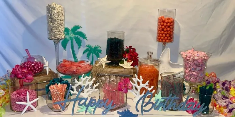 Hawaiian themed candy buffet with coral decorations