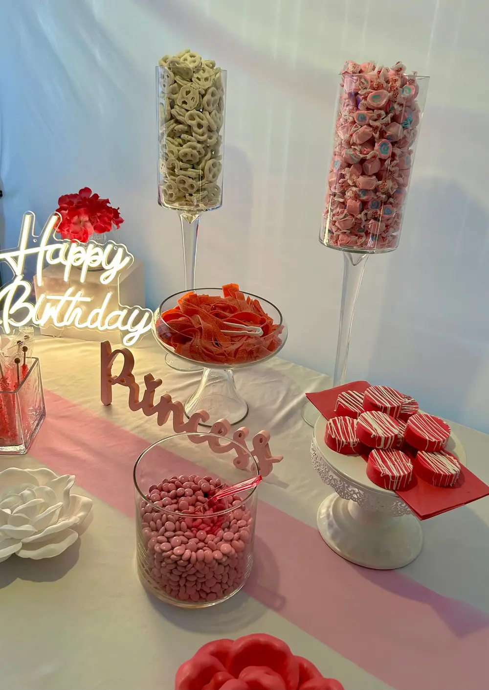 Princess party table with pink candy buffet and themed signage