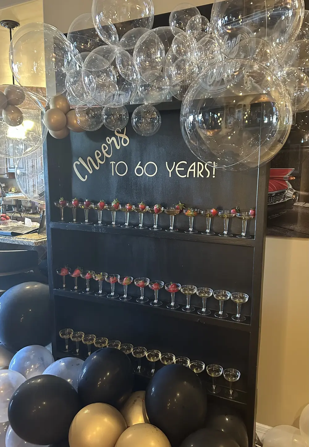 Champagne wall for 60th birthday party with balloon display